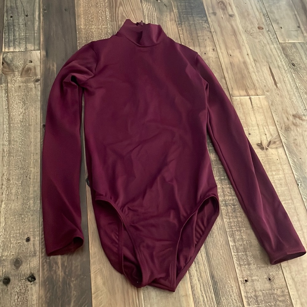 This is a turtle neck maroon leo from Balera. It’s a size MC.